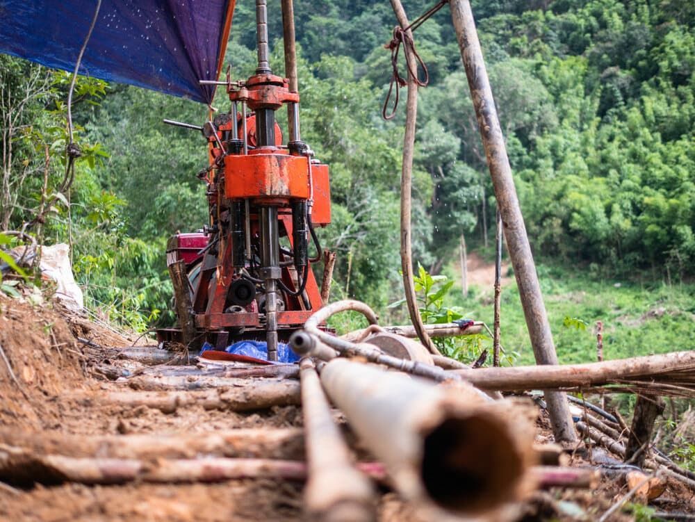 A Machine is Drilling a Hole in the Ground in the Middle of a Forest — FNQ Drilling in Atherton, QLD