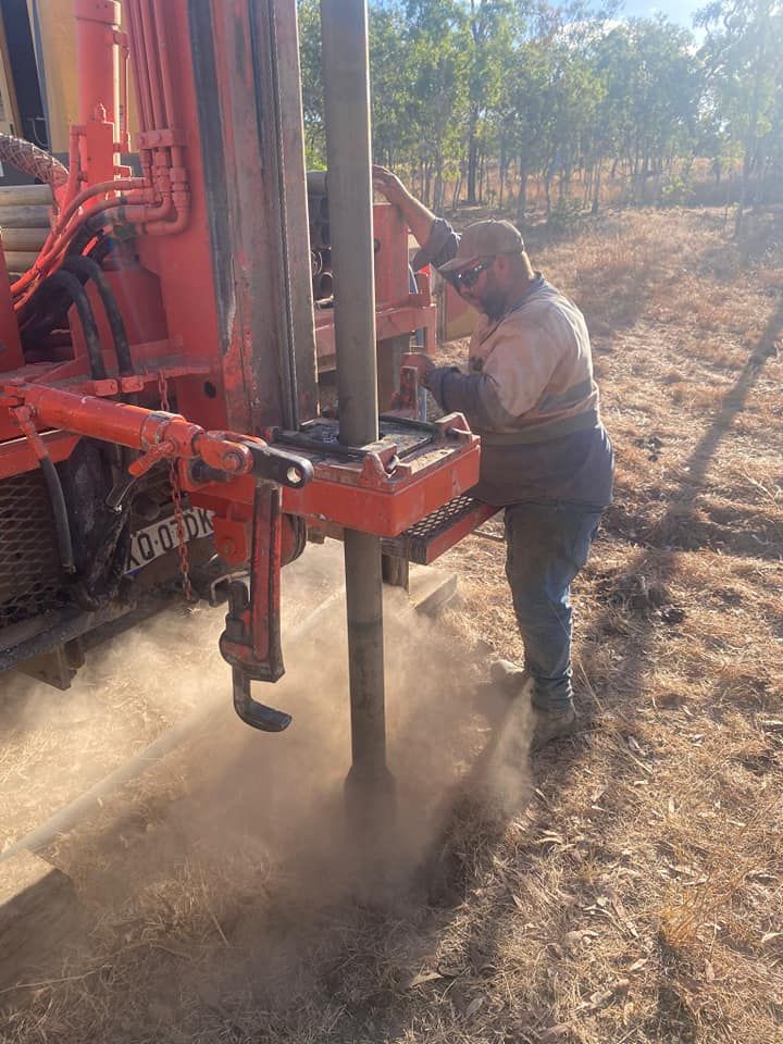 Well Drilling Rig Spraying Water Onto Ground, Blue Casing Visible — FNQ Drilling in Bamboo, QLD