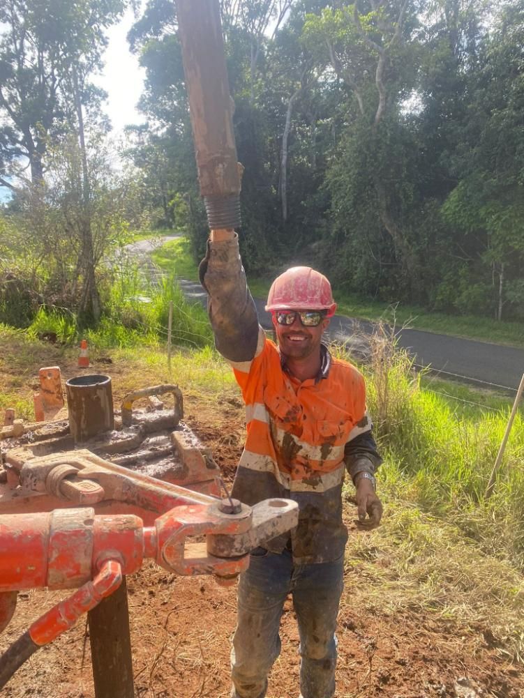 Man With A Hard Hat In The Dirt Field Next To Machine — FNQ Drilling in Bamboo, QLD