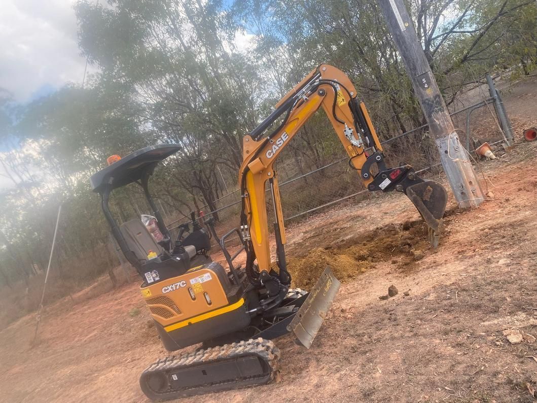 Small Yellow Excavator Is Digging a Hole In The Dirt — FNQ Drilling in Georgetown, QLD