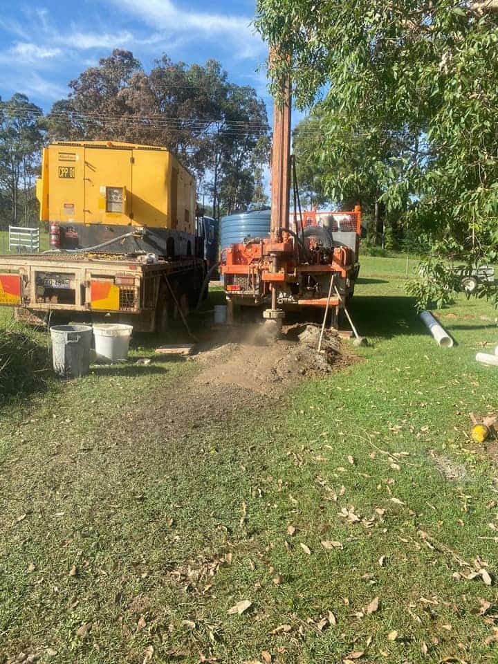 A Truck Is Drilling A Hole In The Ground In A Field — FNQ Drilling in Bamboo, QLD