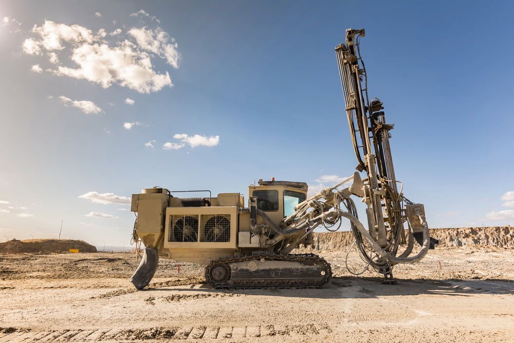 A Large Drill is Sitting in the Middle of a Dirt Field — FNQ Drilling in Babinda, QLD