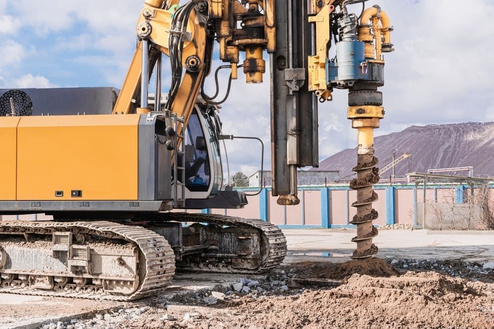 A Bulldozer is Drilling a Hole in the Ground at a Construction Site — FNQ Drilling in Tully, QLD