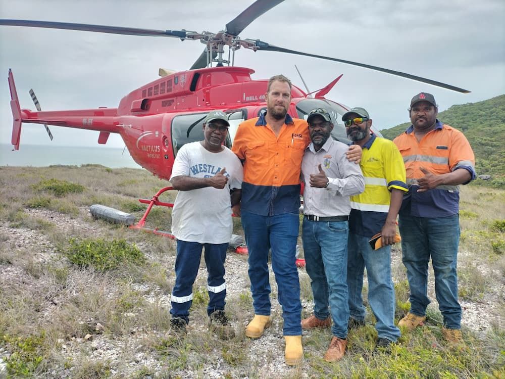 Man Standing In Front of Two Trucks In A Dirt Field — FNQ Drilling in Bamboo, QLD