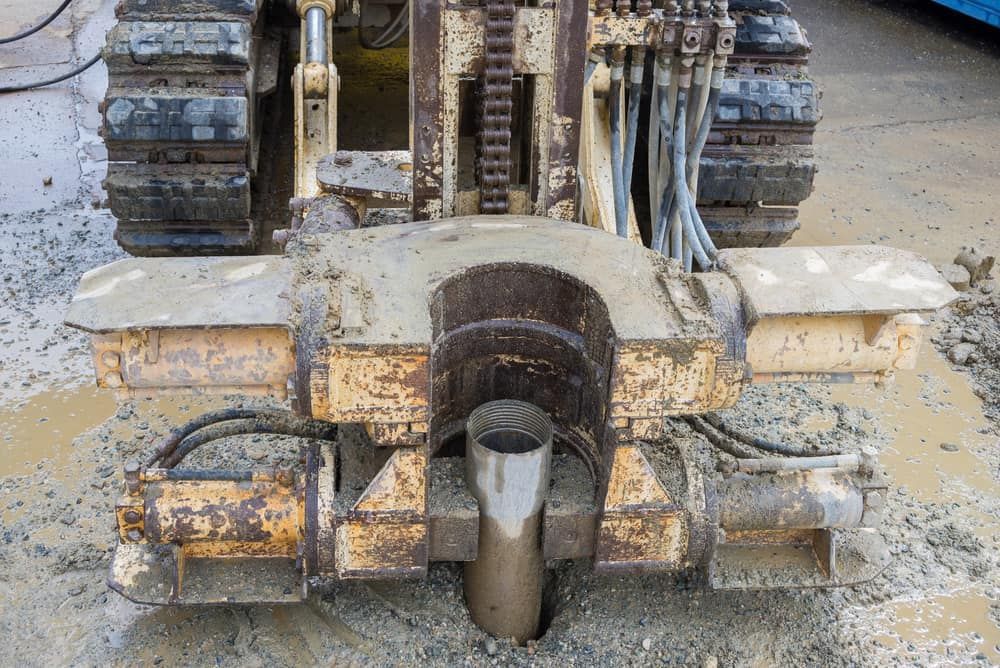 A Machine Is Drilling A Hole In The Ground In A Field — FNQ Drilling in Atherton, QLD