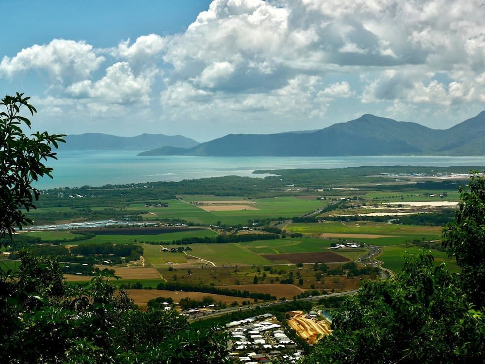 A View of a Large Body of Water With Mountains in the Background — FNQ Drilling in Atherton, QLD