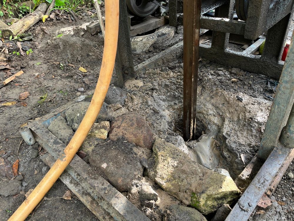 Two Orange Excavators Breaking Rock at a Construction Site — FNQ Drilling in Bamboo, QLD