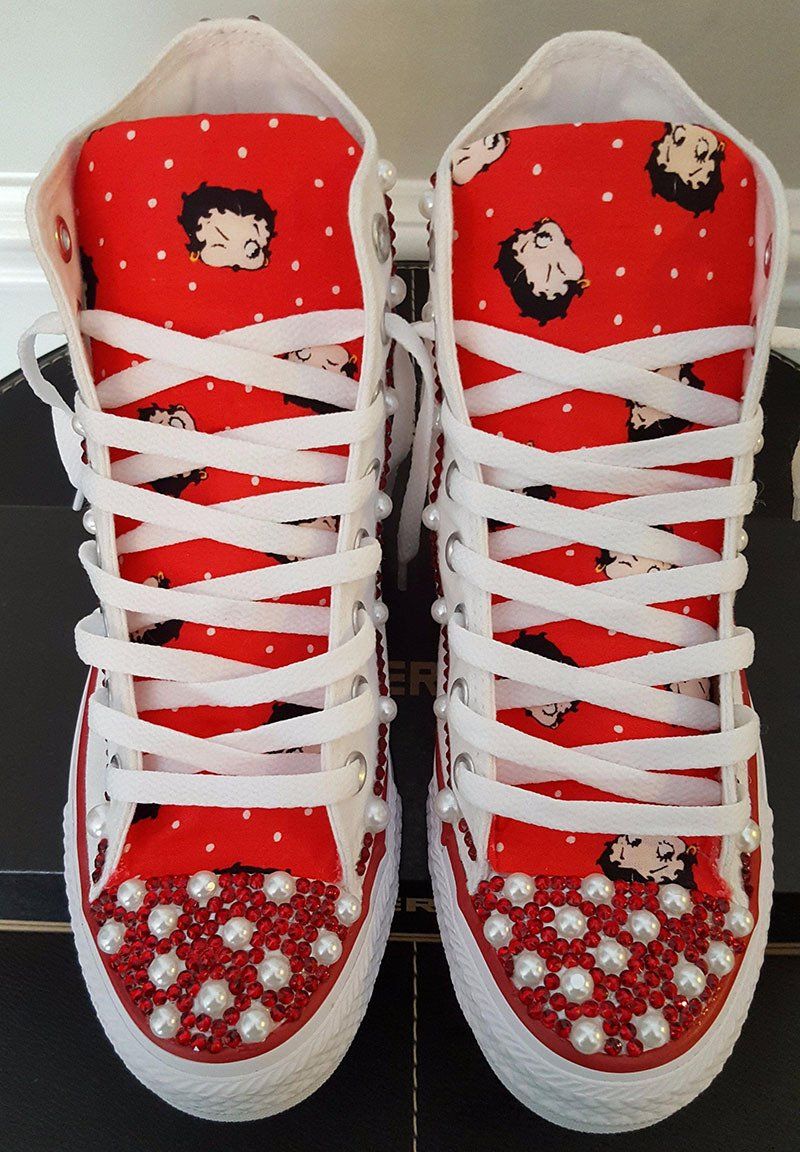 A pair of red and white betty boop high top sneakers