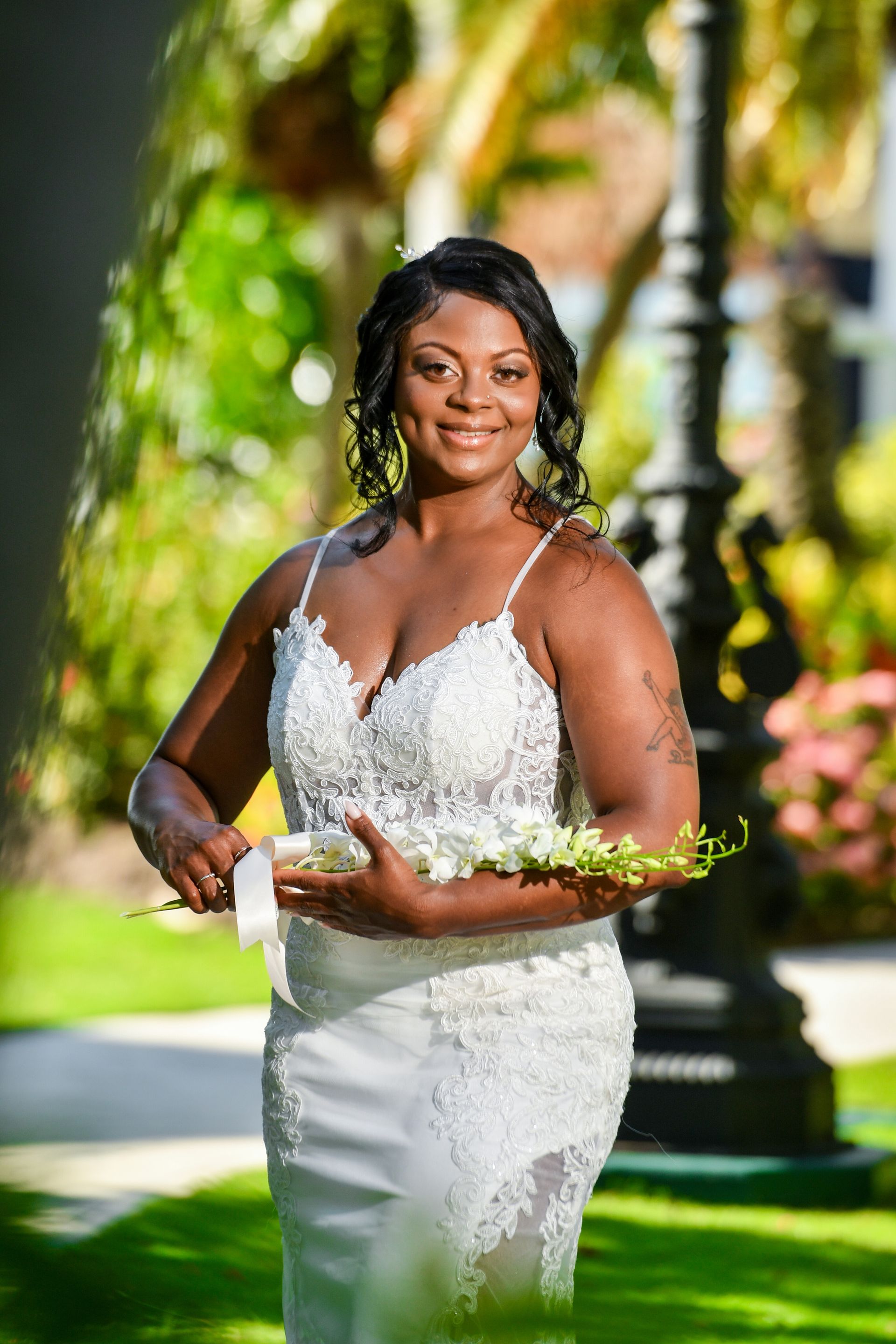 The bride is wearing a white dress and holding a bouquet of flowers.