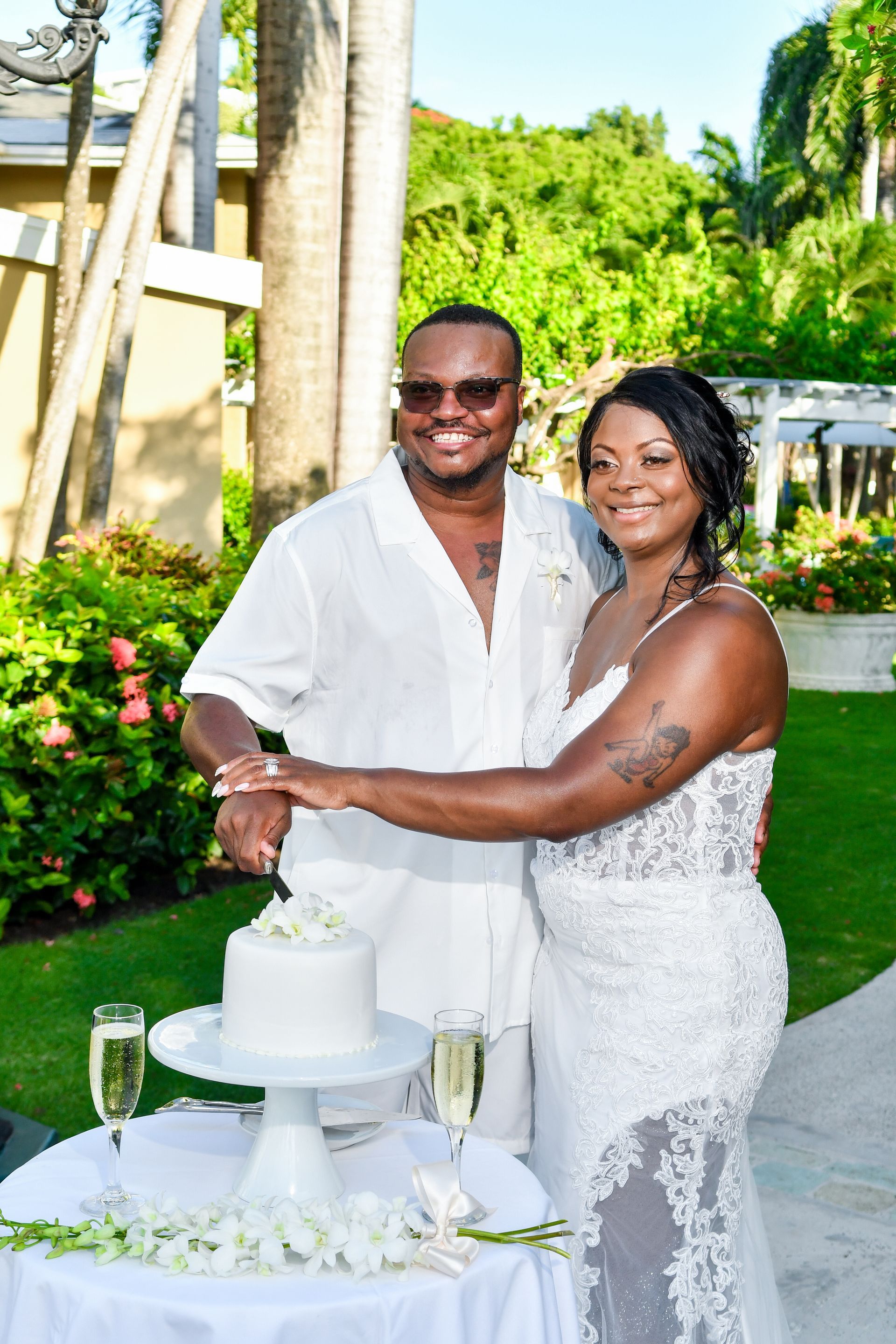 A bride and groom are cutting their wedding cake.