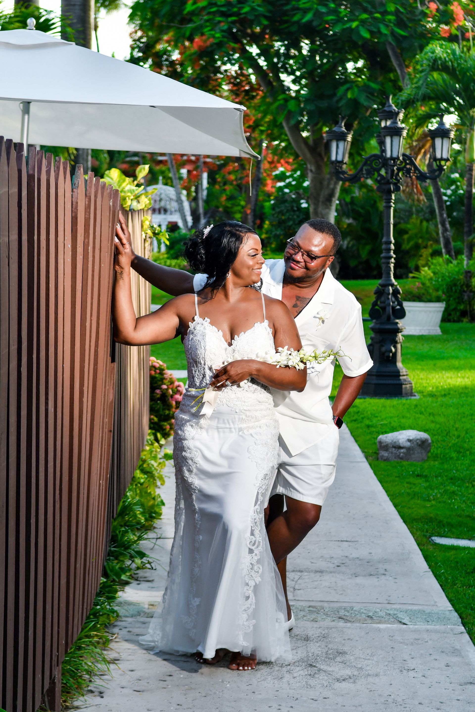 A man and a woman are standing next to each other on a sidewalk.