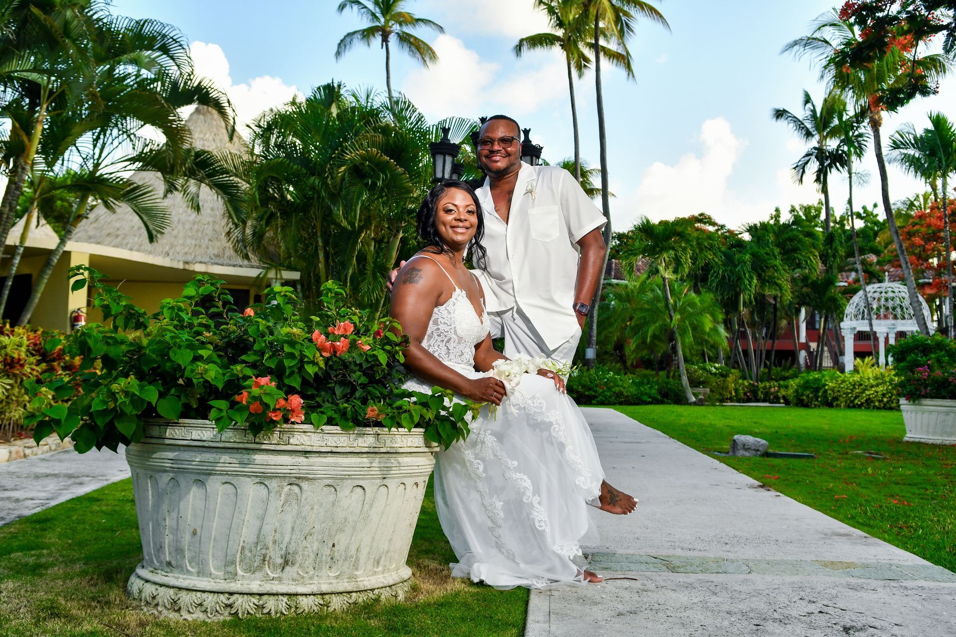A man and a woman are posing for a picture in a park.