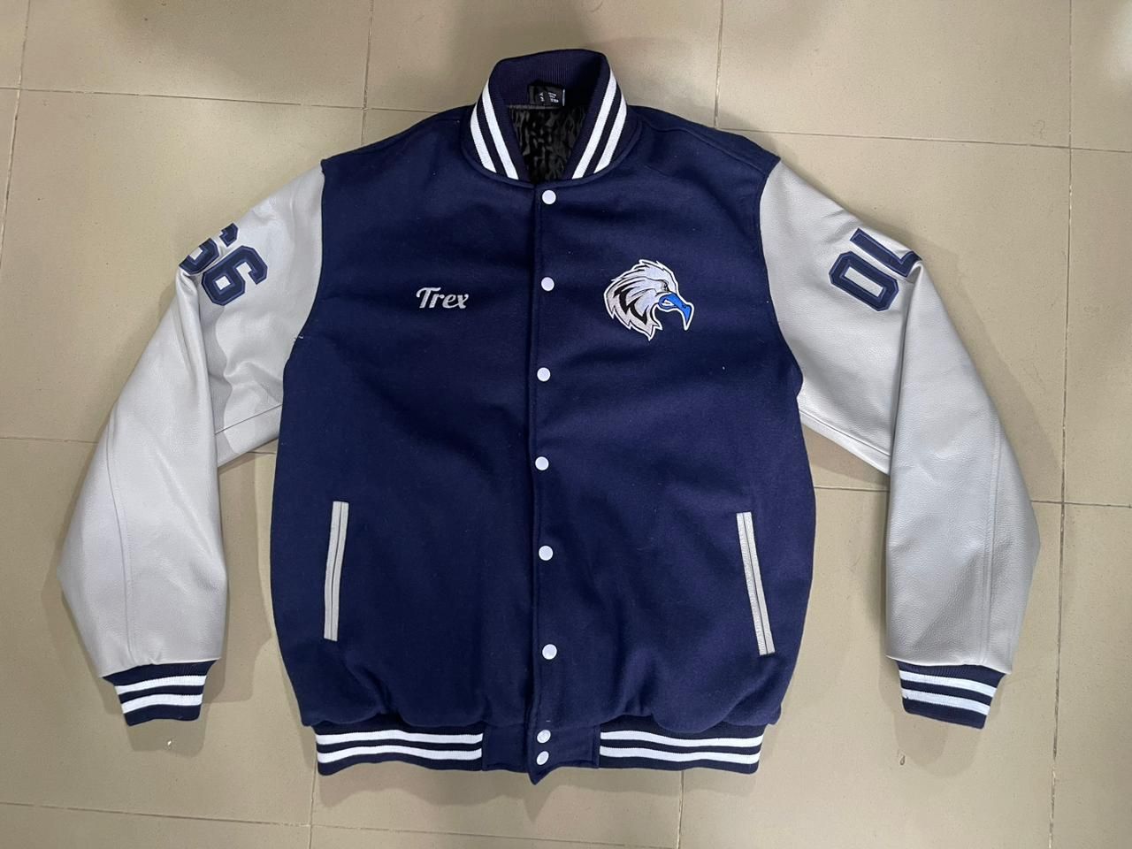 A blue and white baseball jacket with the number 10 on the sleeve