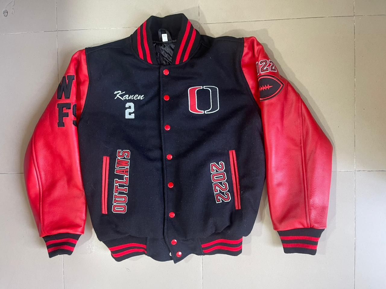 A black and red varsity jacket with the number 2 on it