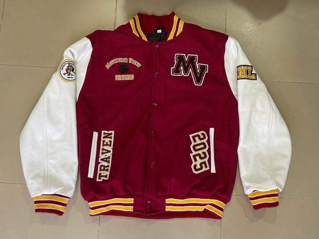 A red and white varsity jacket with patches on the sleeves
