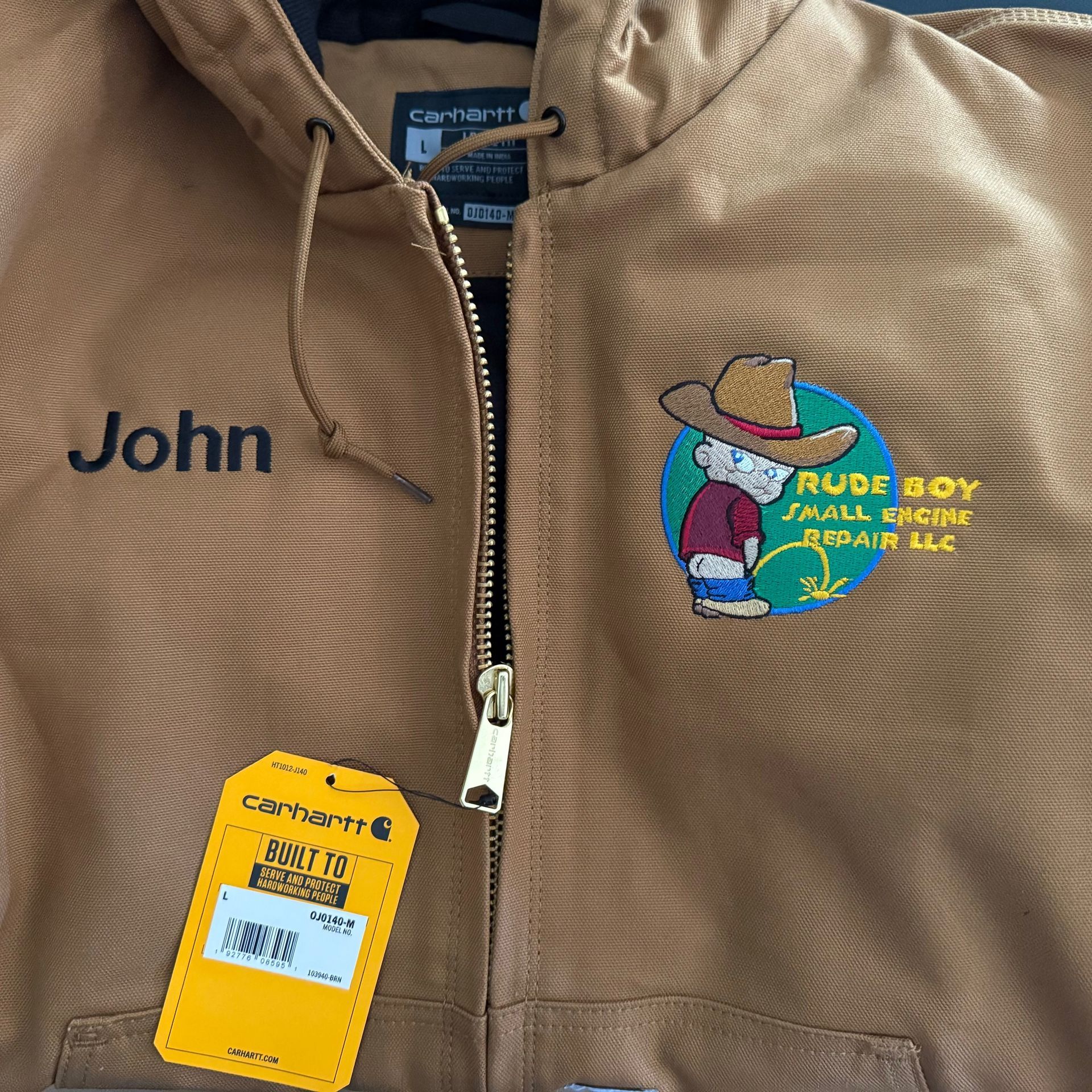 A brown jacket with the name john embroidered on it