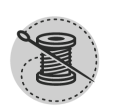 A spool of thread with a needle sticking out of it.