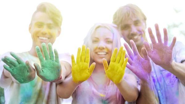 A group of people with their hands painted in different colors.