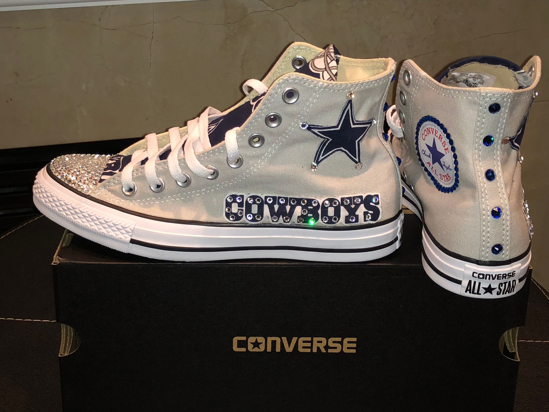 A pair of converse shoes with cowboys written on them