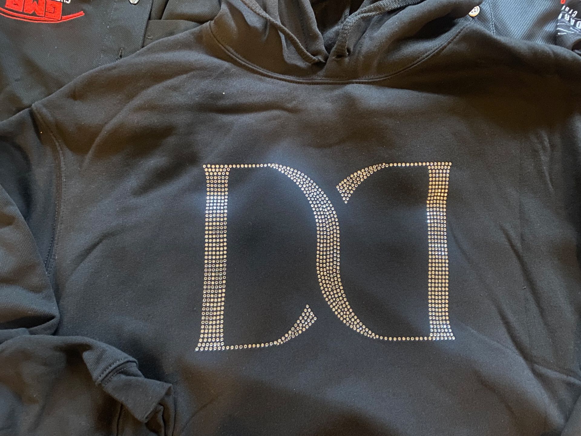 A black hoodie with the letter d on it