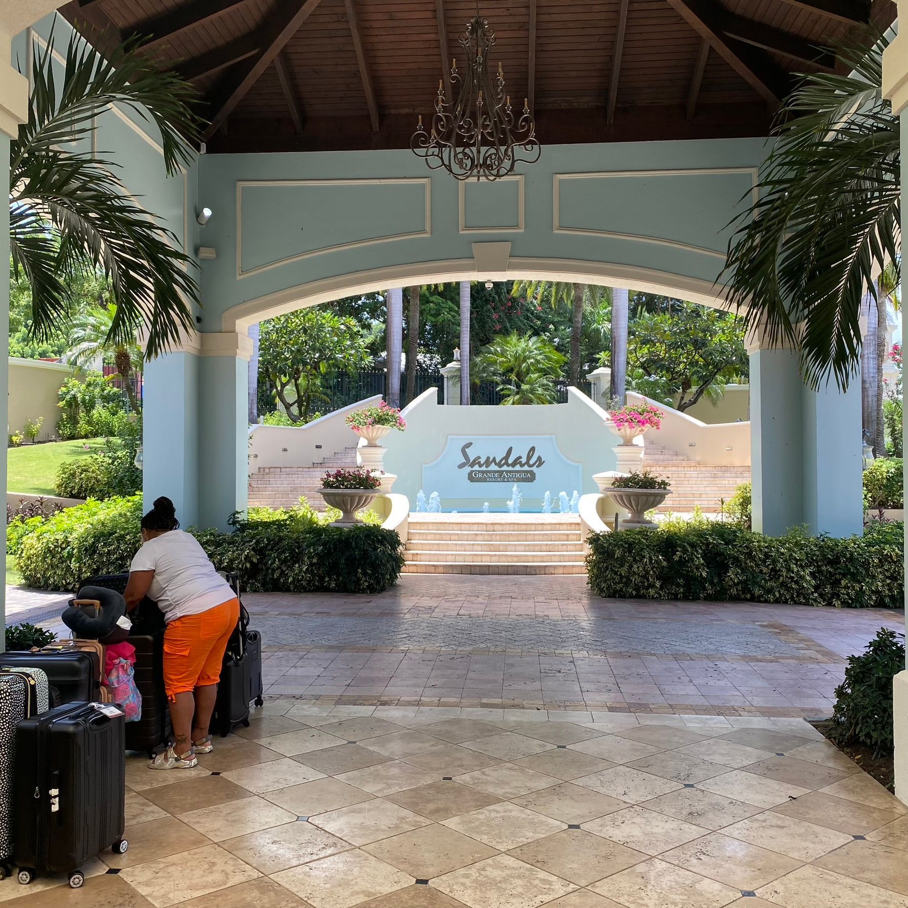 A woman standing in front of a sign that says sandals