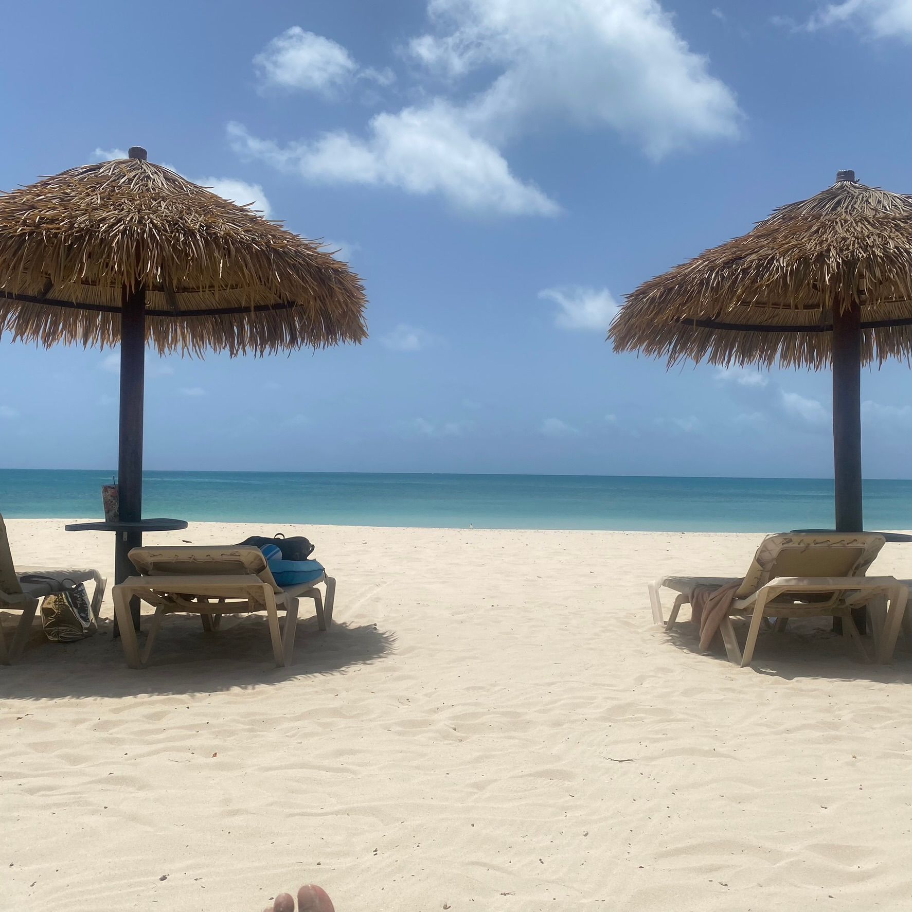 A beach with chairs and umbrellas on a sunny day