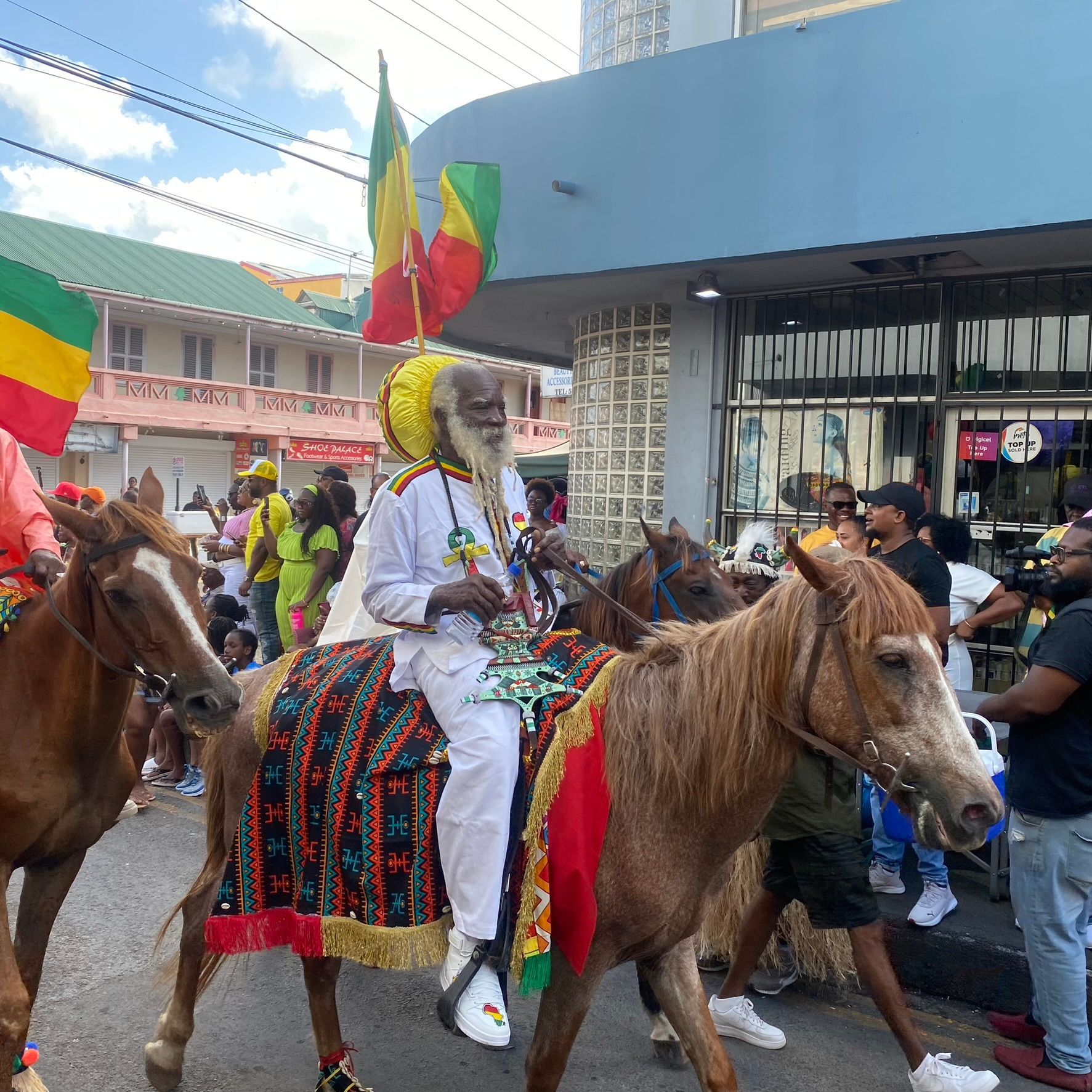 A man with a beard is riding a horse in a parade