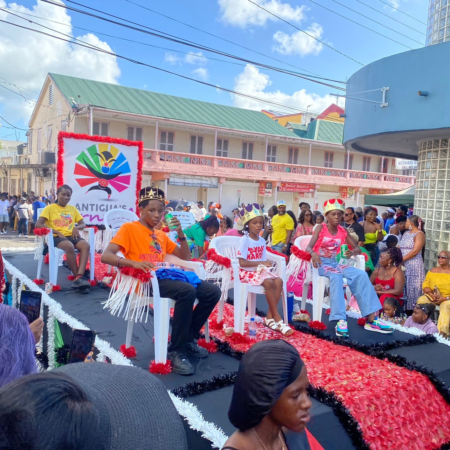 A group of people are sitting on a float in a parade.