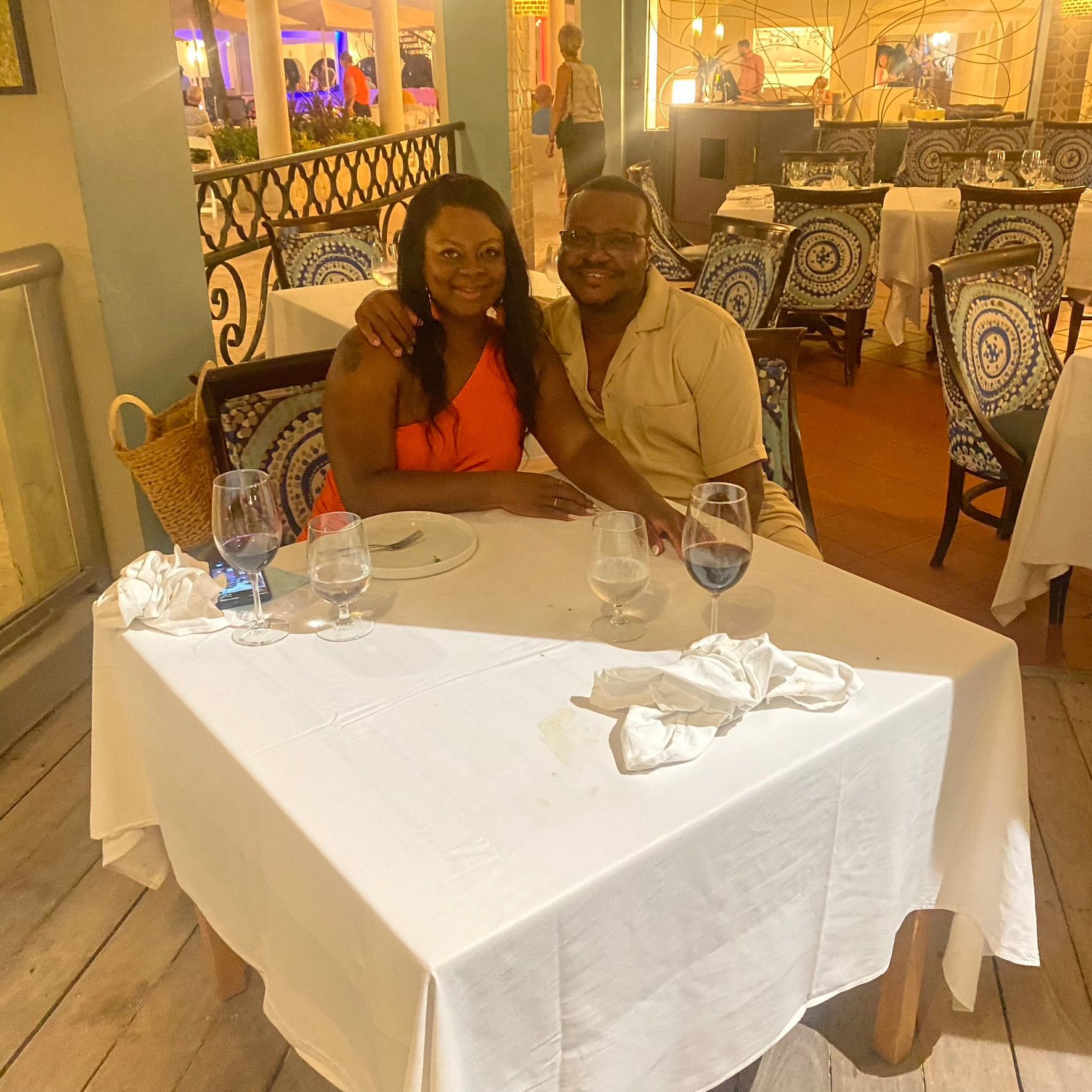 A man and a woman are sitting at a table in a restaurant