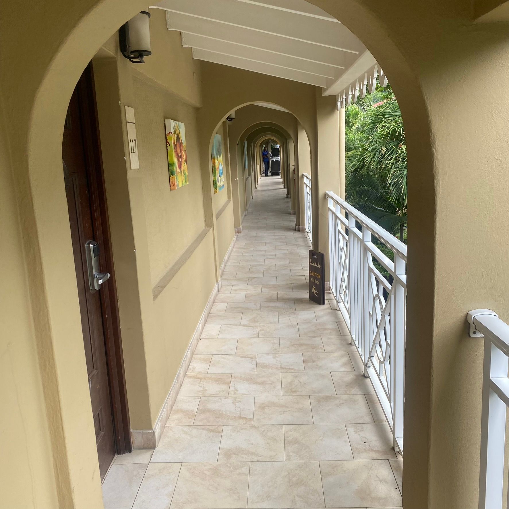 A long hallway in a hotel with a balcony
