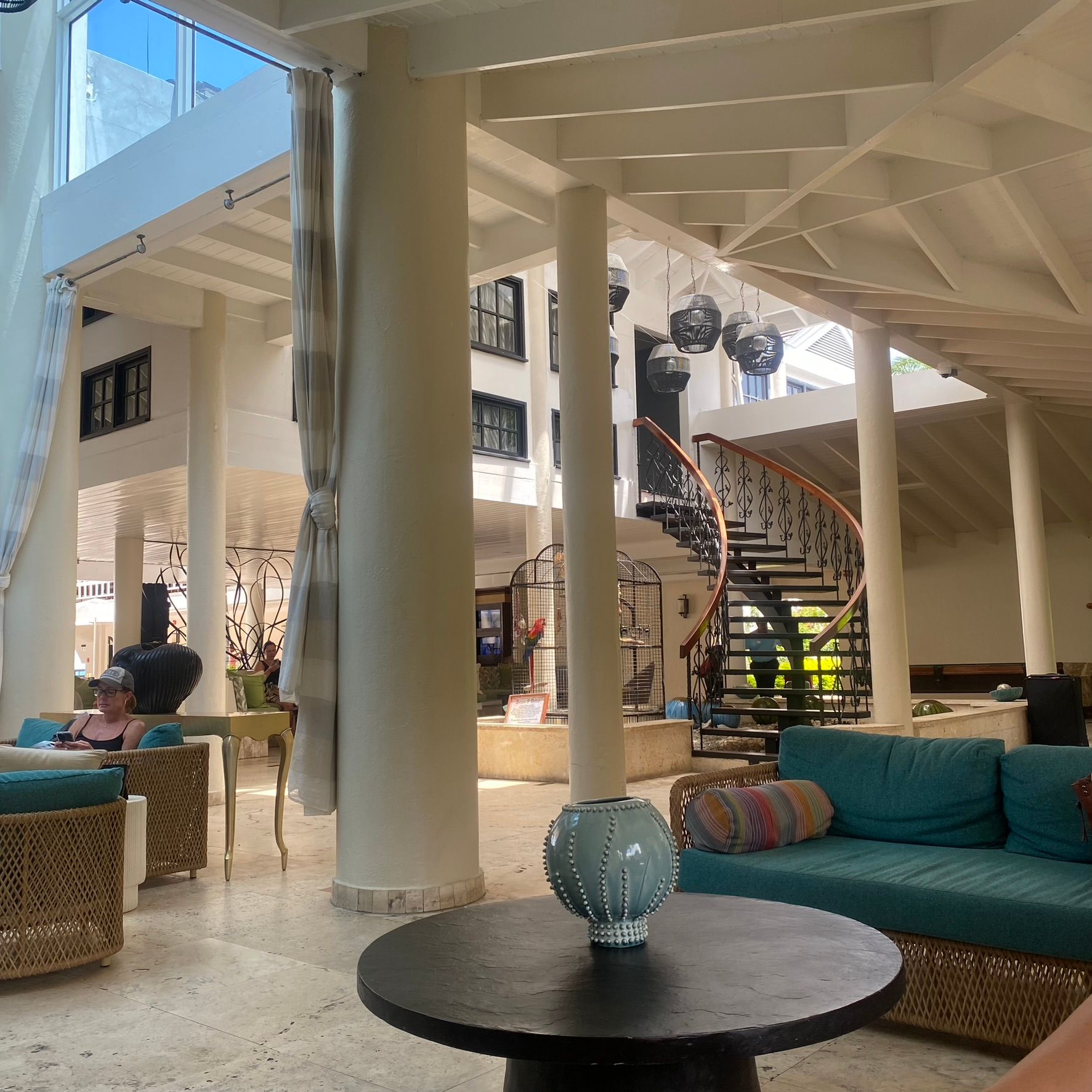 A woman sits on a blue couch in a living room