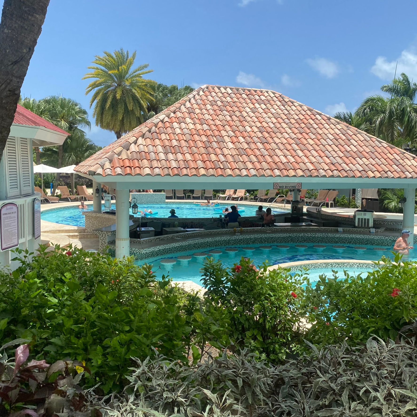A large swimming pool with a gazebo in the foreground