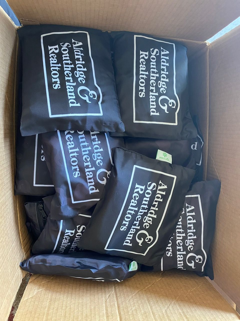 A box filled with albertdge southerland realtors bags