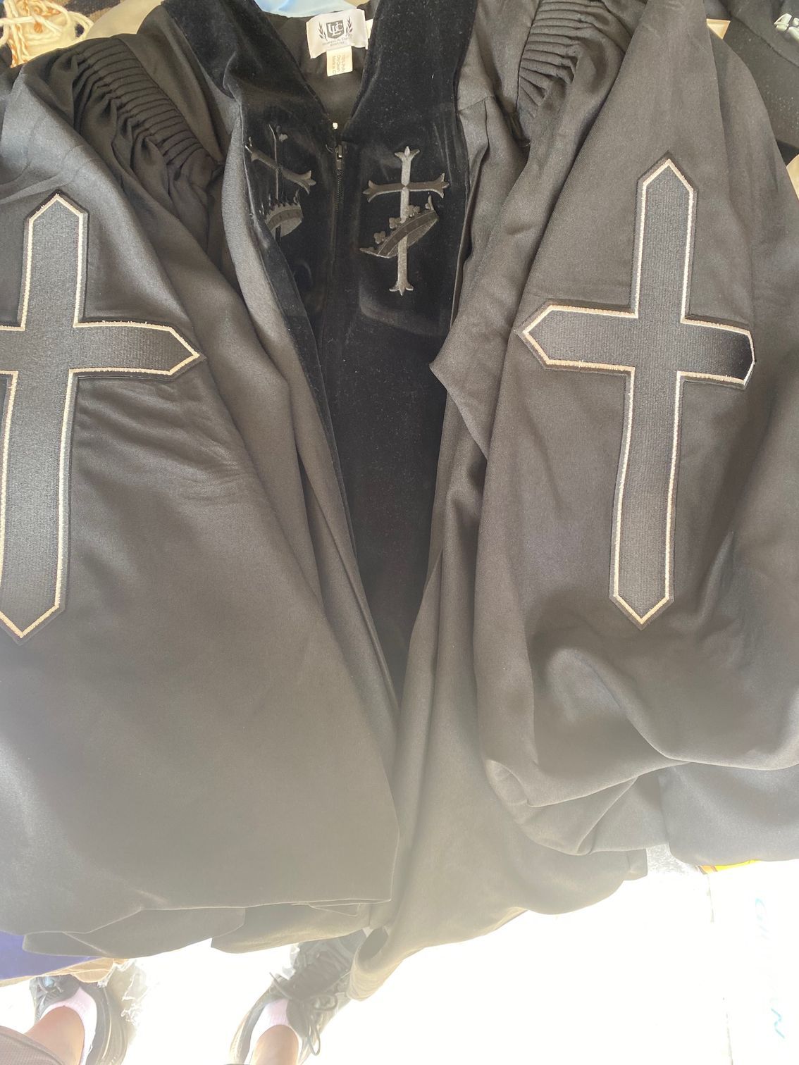 A black jacket with two crosses on the sleeves