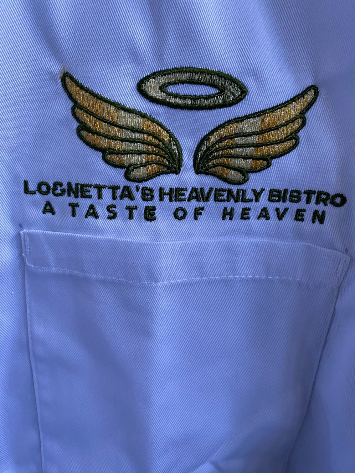 A white shirt with a logo on it that says ' lognetta 's heavenly bistro a taste of heaven '