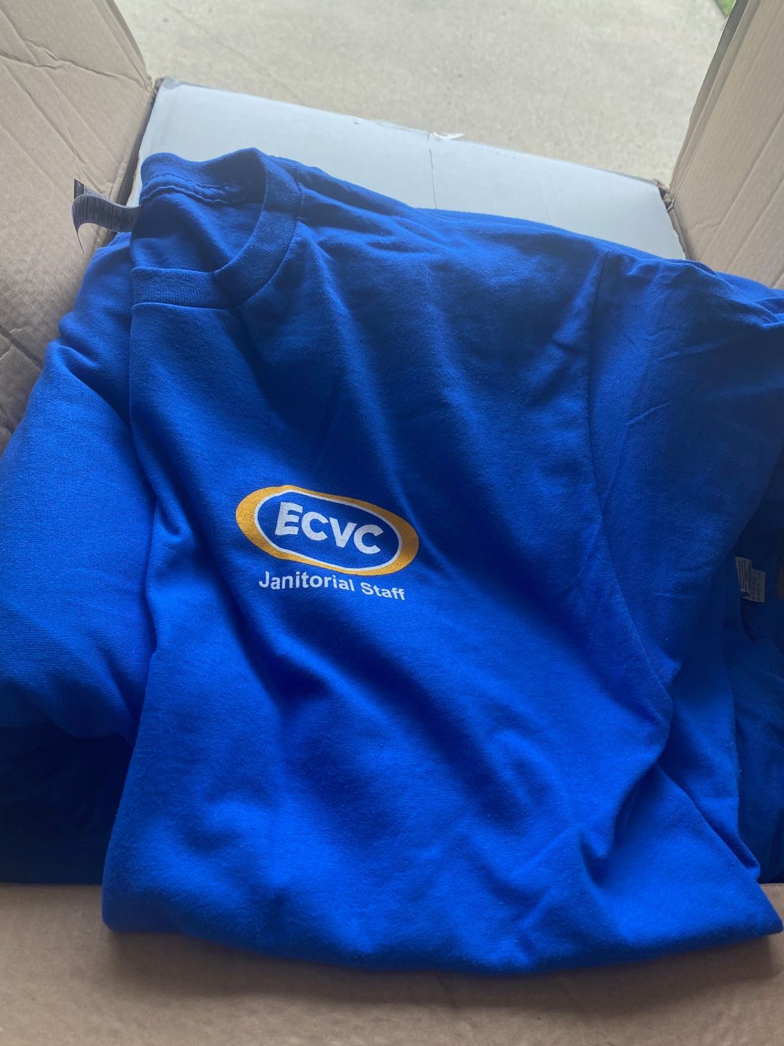 A blue shirt that says ecvc on it