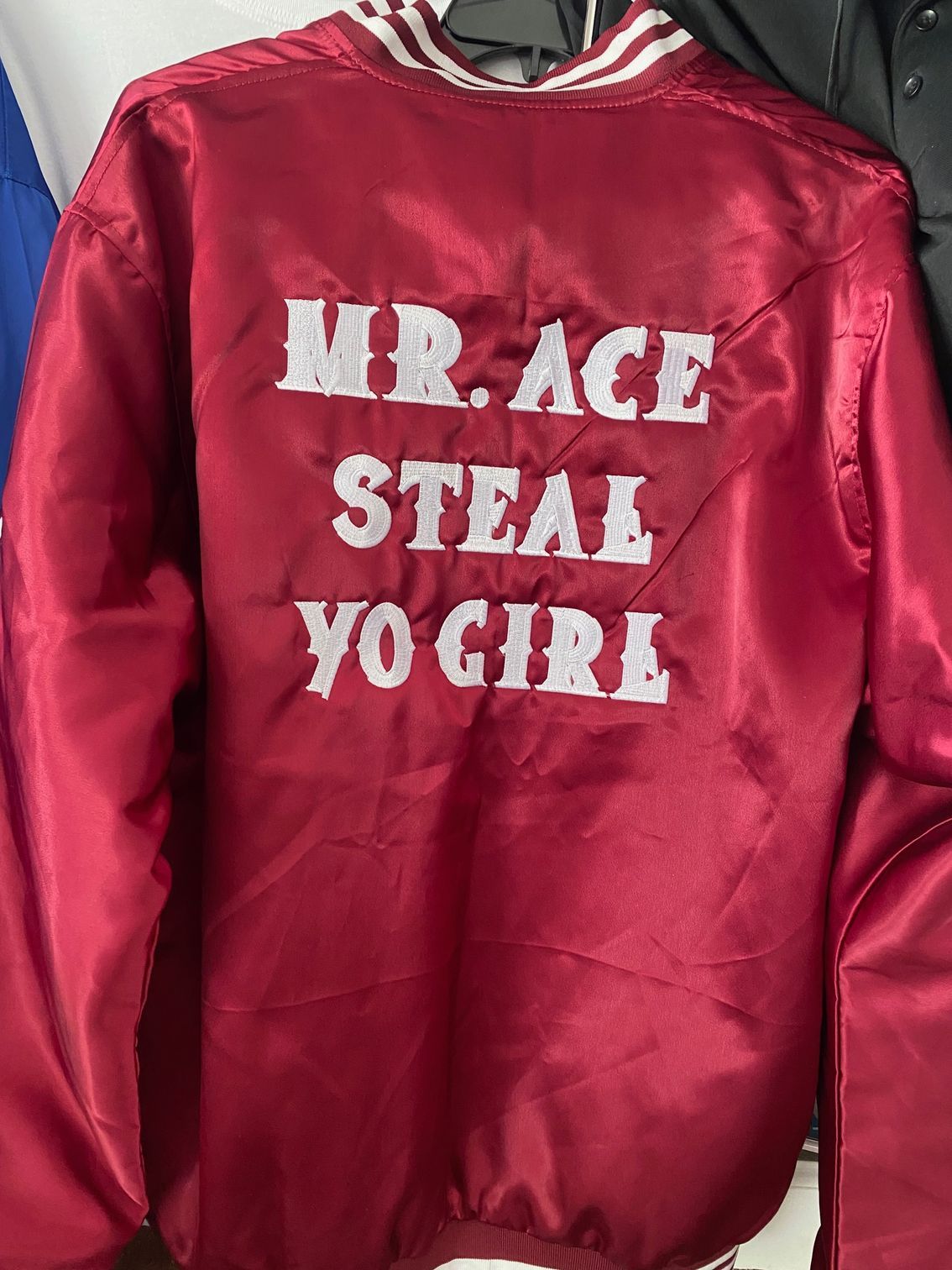 A red jacket with the words mr. ace steal yo girl embroidered on it