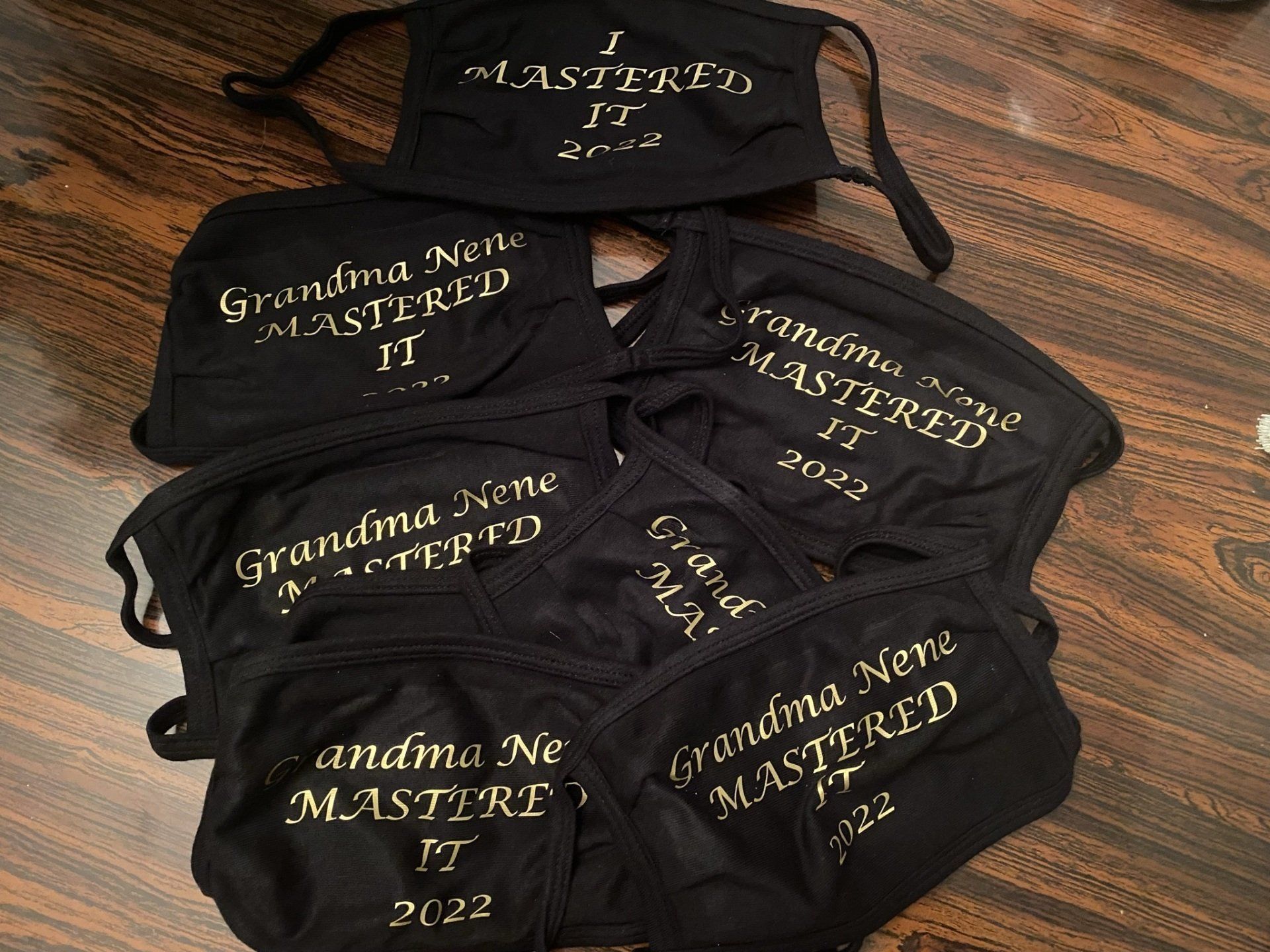 A bunch of face masks are sitting on a wooden table.