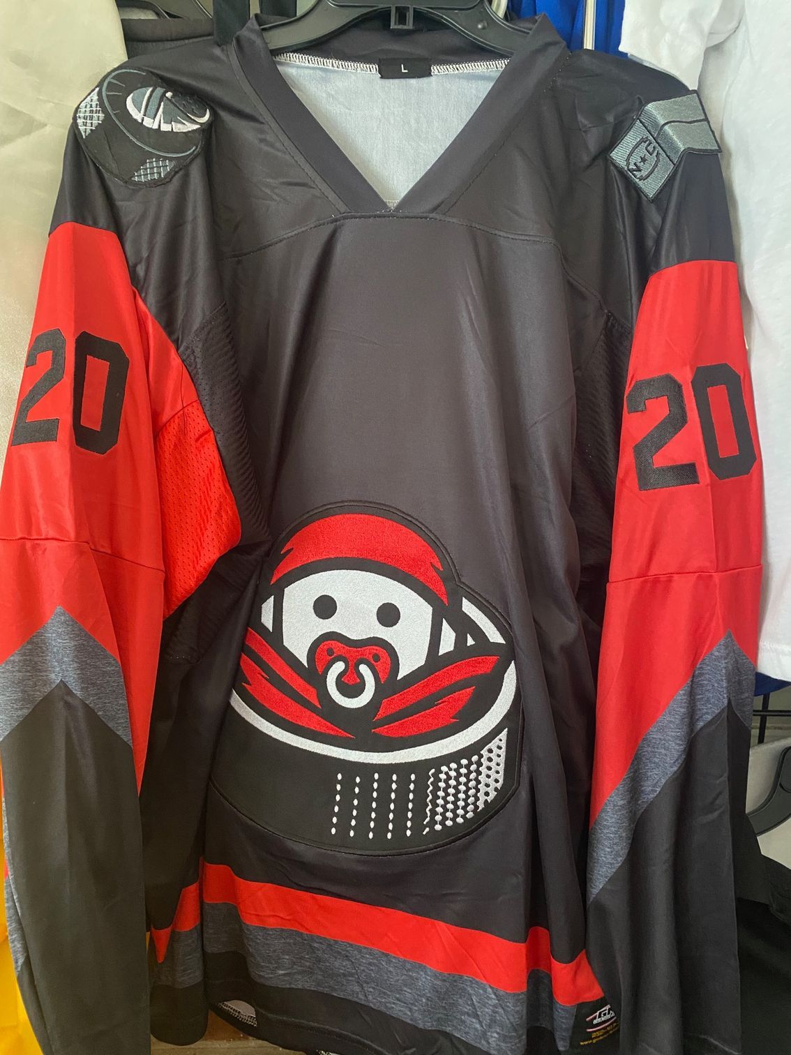 A black and red hockey jersey with the number 20 on the sleeves