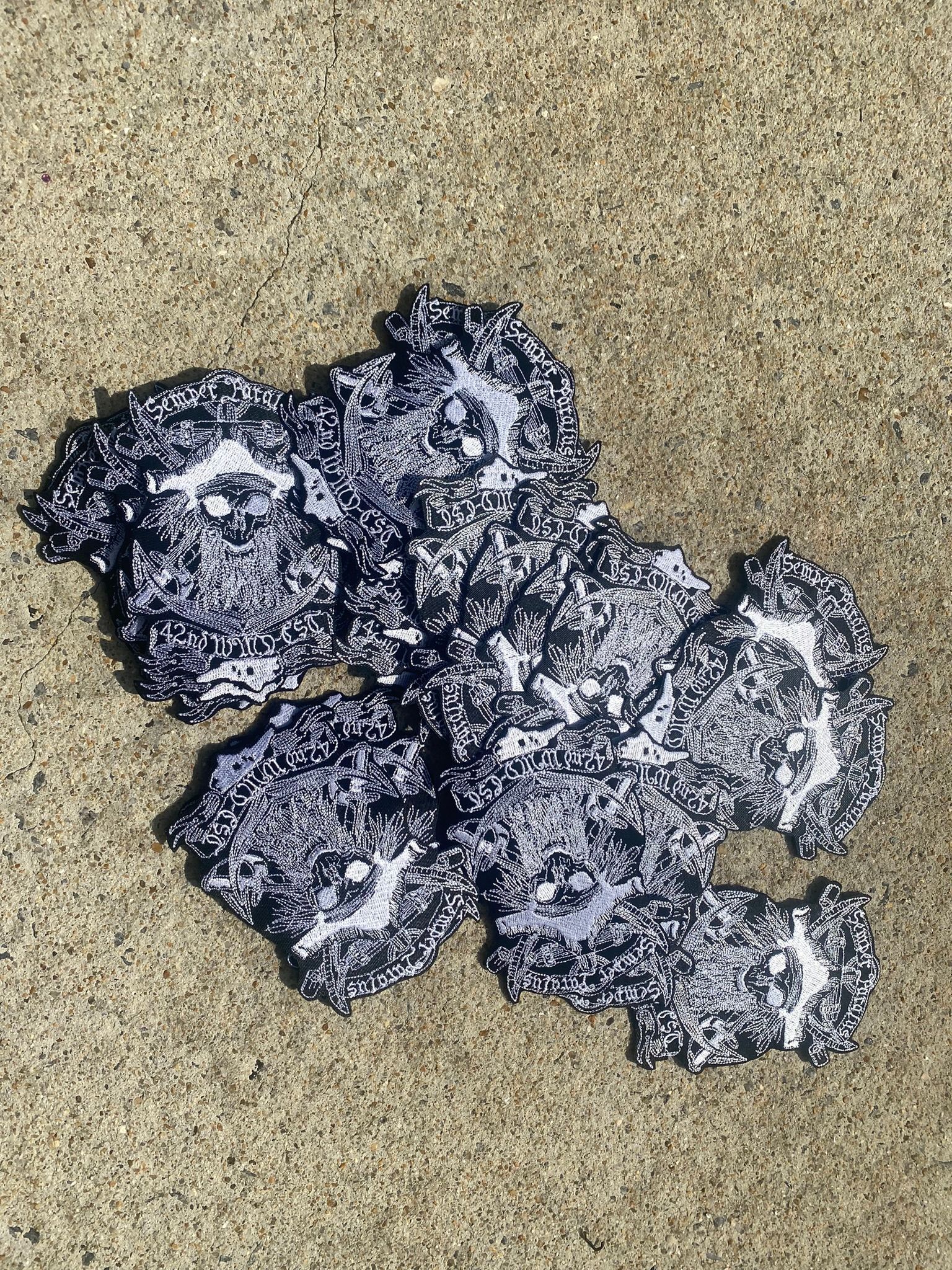 A group of coasters are sitting on top of a sandy surface.