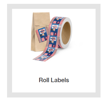A roll of roll labels is sitting next to a brown bag.
