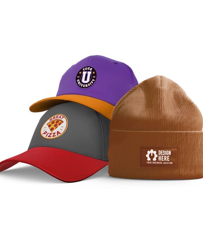 A brown beanie and a green baseball cap are on a wooden table.