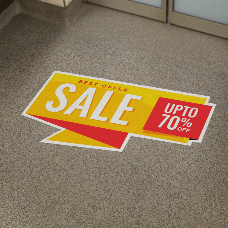 A sign on the floor that says sale upto 70 % off