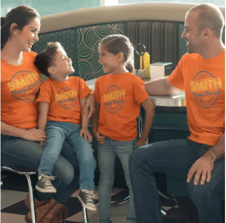 A family wearing orange shirts with the name smith on them
