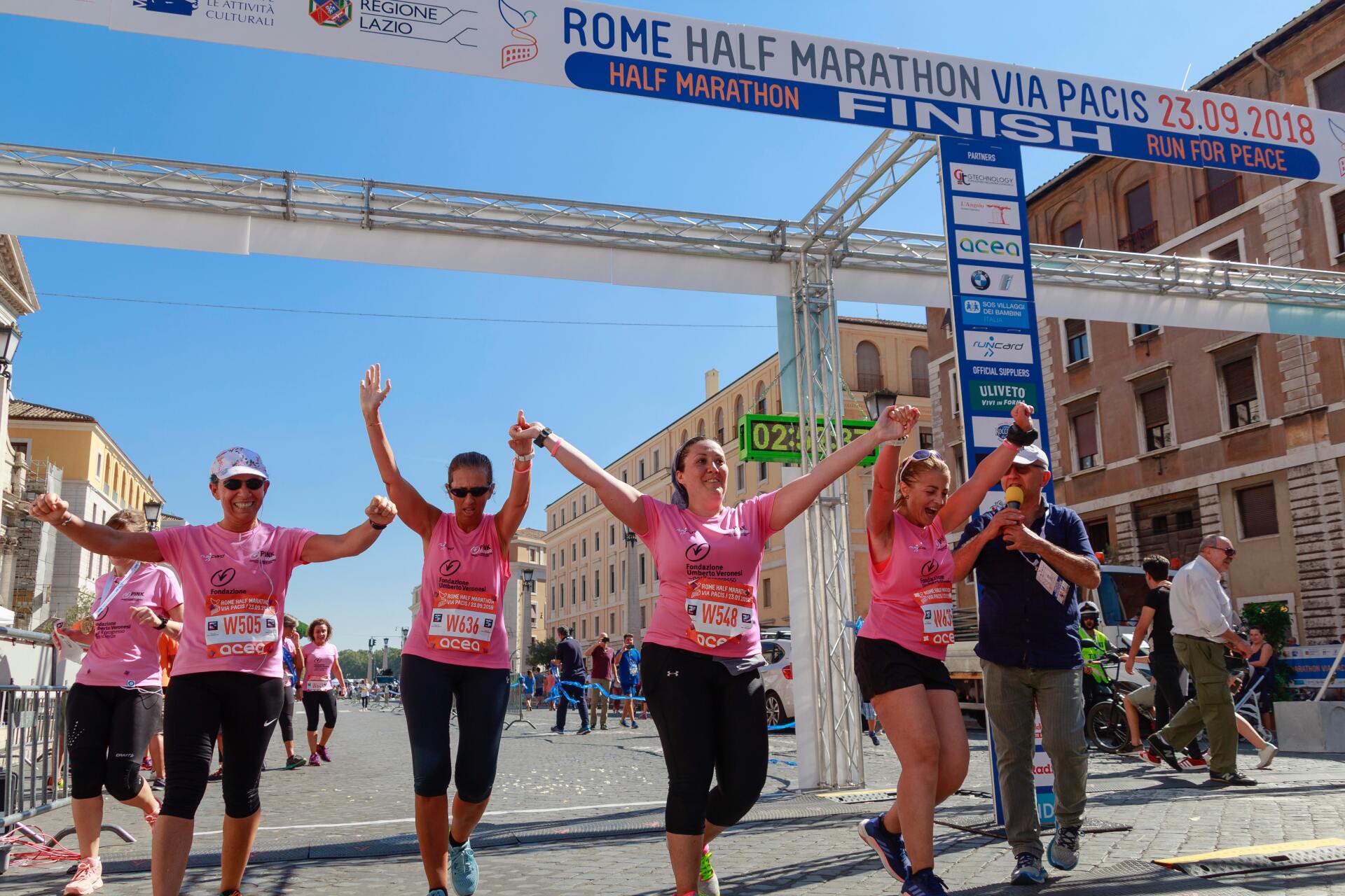 A group of people are running a half marathon in rome
