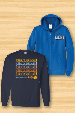 A blue hoodie and a black sweatshirt are on a wooden table