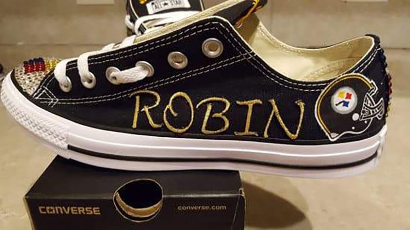 A pair of converse shoes with the name robin painted on them