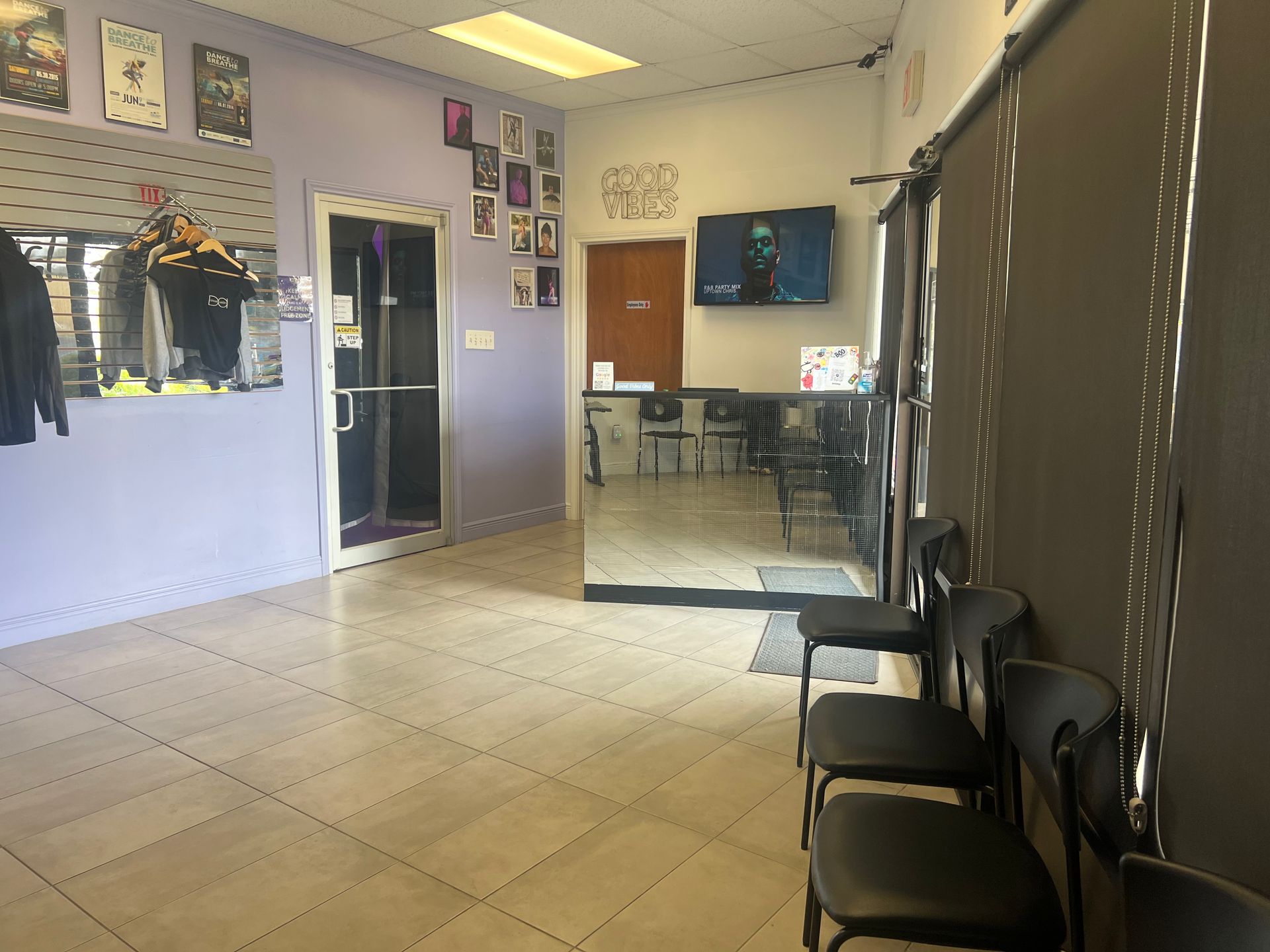 A waiting room with chairs and a tv on the wall