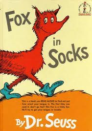 the cover of the book fox in socks by dr. seuss shows a red fox wearing blue socks .