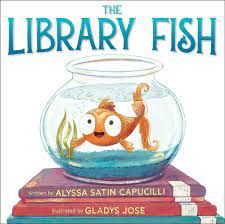 a fish is swimming in a bowl on top of a stack of books .